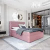 A bedroom scene featuring a pink upholstered bed with a tufted headboard, a gray comforter, and decorative mirrors on the wall. Náhled obrázku produktu