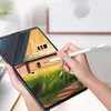 A person is using a stylus pen to draw on a tablet, which displays a digital painting of a house and landscape. Produktbild-Vorschau