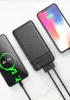 A black power bank is charging two smartphones. Produktbild-Vorschau