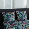 A close-up view of a bed with a patterned duvet cover and pillows. Produktbild-Vorschau
