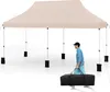 A man is walking with a black carrying bag in front of a beige pop-up tent. Náhled obrázku produktu