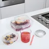 Food containers and a glass of juice on a kitchen counter. Produktbild-Vorschau