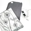 A gray heating pad and a decorative pillow are placed on a white background. Produktbild-Vorschau