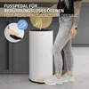A person is using a white pedal bin in a kitchen setting. Podgląd zdjęcia produktu