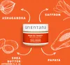 A jar of face cream is shown in the center, surrounded by illustrations of its key ingredients: Ashwagandha, Saffron, Shea Butter, and Papaya. Produktbild-Vorschau