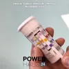 A hand holds a test strip container with a test strip partially pulled out, showing color-coded results. Produktbild-Vorschau