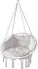 A white hanging chair with cushions and tassels, suspended by ropes.