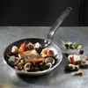 A de BUYER CHOC RESTO pan filled with seafood and fish, presented on a metallic surface with some decorative elements. Podgląd zdjęcia produktu