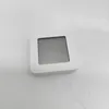 A white, square digital device with a gray screen sits on a white surface. Podgląd zdjęcia produktu