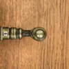 A close-up view of a door handle on a wooden surface. Produktbild-Vorschau