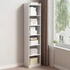A tall, narrow white bookshelf filled with various items, placed next to a window with curtains. Produktbild-Vorschau