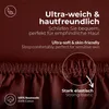 Close-up of a brown fabric with text overlays highlighting product features. Produktbild-Vorschau