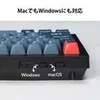 A close-up of a black and gray keyboard with a red keycap, showing a switch for Windows/macOS compatibility. Produktbild-Vorschau