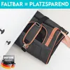 A person is placing a pet carrier bag into a drawer, demonstrating its space-saving feature. Produktbild-Vorschau