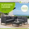 An outdoor lounge set with a coffee table and side table, set against a backdrop of a building and the sea. Produktbild-Vorschau