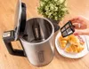 A person is holding a tea filter over an open electric kettle, with croissants on a plate next to it. Náhled obrázku produktu