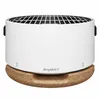 A white tabletop grill with a black grate sits on a cork base. Produktbild-Vorschau