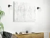 A modern living room scene with a wall-mounted light fixture and a wooden cabinet. Podgląd zdjęcia produktu