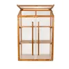 A wooden and polycarbonate mini greenhouse with shelves and two doors, shown against a white background. Voir les images du produit