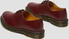 A pair of burgundy leather shoes with black laces and yellow stitching on a white background. Produktbild-Vorschau