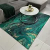 A rug with a marble pattern is placed in a living room setting, in front of a sofa and coffee table. Náhled obrázku produktu