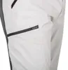 A close-up view of the side of a pair of light-colored pants, showing a zippered pocket. Produktbild-Vorschau