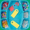 A top-down view of a LEGO DOTS creative set in a turquoise tray. Produktbild-Vorschau