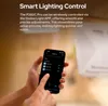 A person is holding a smartphone displaying an app, with a product in the background. Produktbild-Vorschau