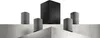 A home theater sound system with a subwoofer and four satellite speakers arranged on a tiered platform. Produktbild-Vorschau