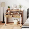 A vanity desk with makeup and accessories, next to a floor lamp and a bed. Produktbild-Vorschau