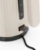 Close-up of a cream-colored electric kettle, showing the water level indicator and the power switch. Podgląd zdjęcia produktu