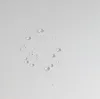 Close-up of water droplets on a white textured surface. Produktbild-Vorschau