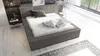 A modern bedroom with a bed, nightstand, and rug. Produktbild-Vorschau