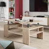 A modern living room with a coffee table in the foreground, a TV and entertainment unit in the background, and a bookshelf on the left. Voir les images du produit
