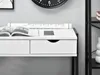A close-up shot of a white desk with black accents, showing drawers, a magazine, a phone, and a rolled-up blueprint. Voir les images du produit