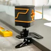 A close-up shot of a green laser level device mounted on a clamp, with a yellow bubble level in the background. Náhľad obrázku produktu