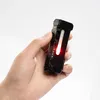 A hand holds a small black flashlight with a red light illuminated. Náhľad obrázku produktu