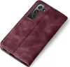 A burgundy flip cover case for a smartphone is shown against a white background. Produktbild-Vorschau