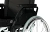 A close-up view of the rear section of a wheelchair, focusing on the wheel and armrest. Produktbild-Vorschau