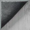 The underside of a rug is shown, partially covering a wooden surface. Produktbild-Vorschau
