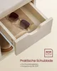 A close-up view of an open drawer in a wooden furniture piece, showcasing a pair of sunglasses and a shoe. Text overlays describe the drawer's features. Produktbild-Vorschau