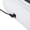 A close-up shot of a black power adapter plugged into a white electronic device. Podgląd zdjęcia produktu