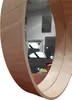 A close-up view of a round mirror with a wooden frame, reflecting a room. Náhled obrázku produktu