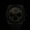 A close-up shot of a Casio Edifice chronograph watch with luminous hands and markers glowing in the dark. Voir les images du produit