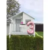 A children's playhouse in a garden with a large number '3' balloon. Produktbild-Vorschau