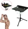 A tattoo workstation on a tripod stand and a tattooed man. Náhled obrázku produktu