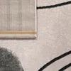 A close-up view of a rug, showing the texture and part of the backing. Produktbild-Vorschau