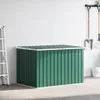 A green storage box with a white lid in a garage or storage area. Produktbild-Vorschau