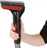 A person's hand holding a cleaning attachment for a carpet cleaner. Voir les images du produit