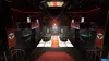 A dimly lit, opulent casino or club interior with red accents and gaming tables. Produktbild-Vorschau
